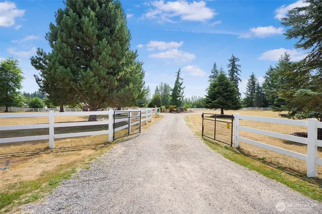a view of a house with a yard and sitting area