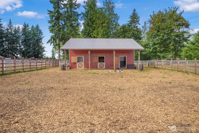 a view of a livingroom with couch and a potted plant