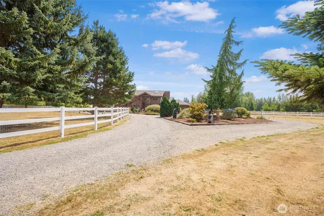 a front view of a house with a yard and a garage
