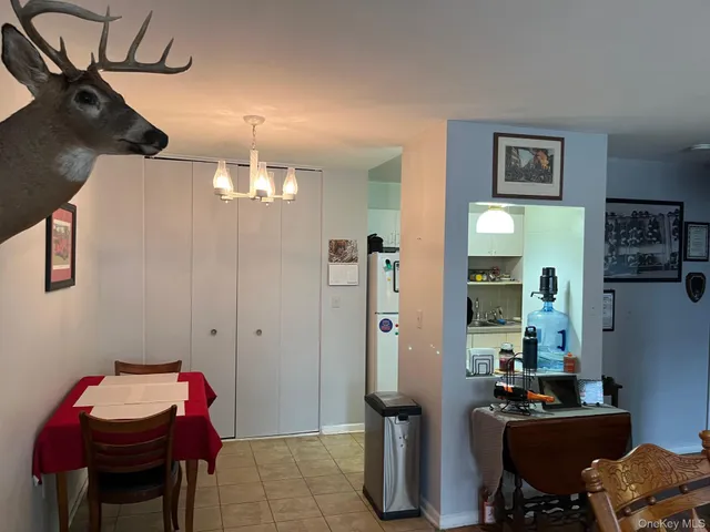 a view of a workspace with furniture and gym equipment