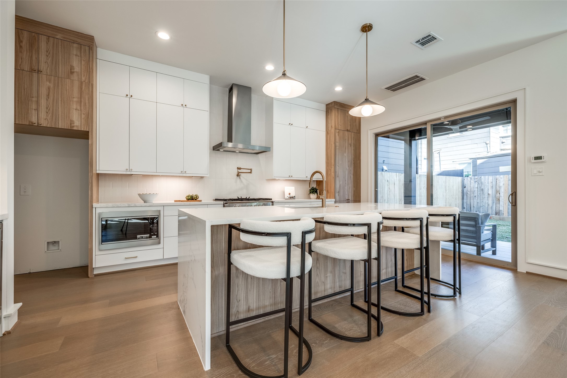 1601 Vermont Street Houston, TX 77006 - Photo 20 of 49 a kitchen with stainless steel appliances granite countertop a stove top oven a sink a dining table and chairs with wooden floor