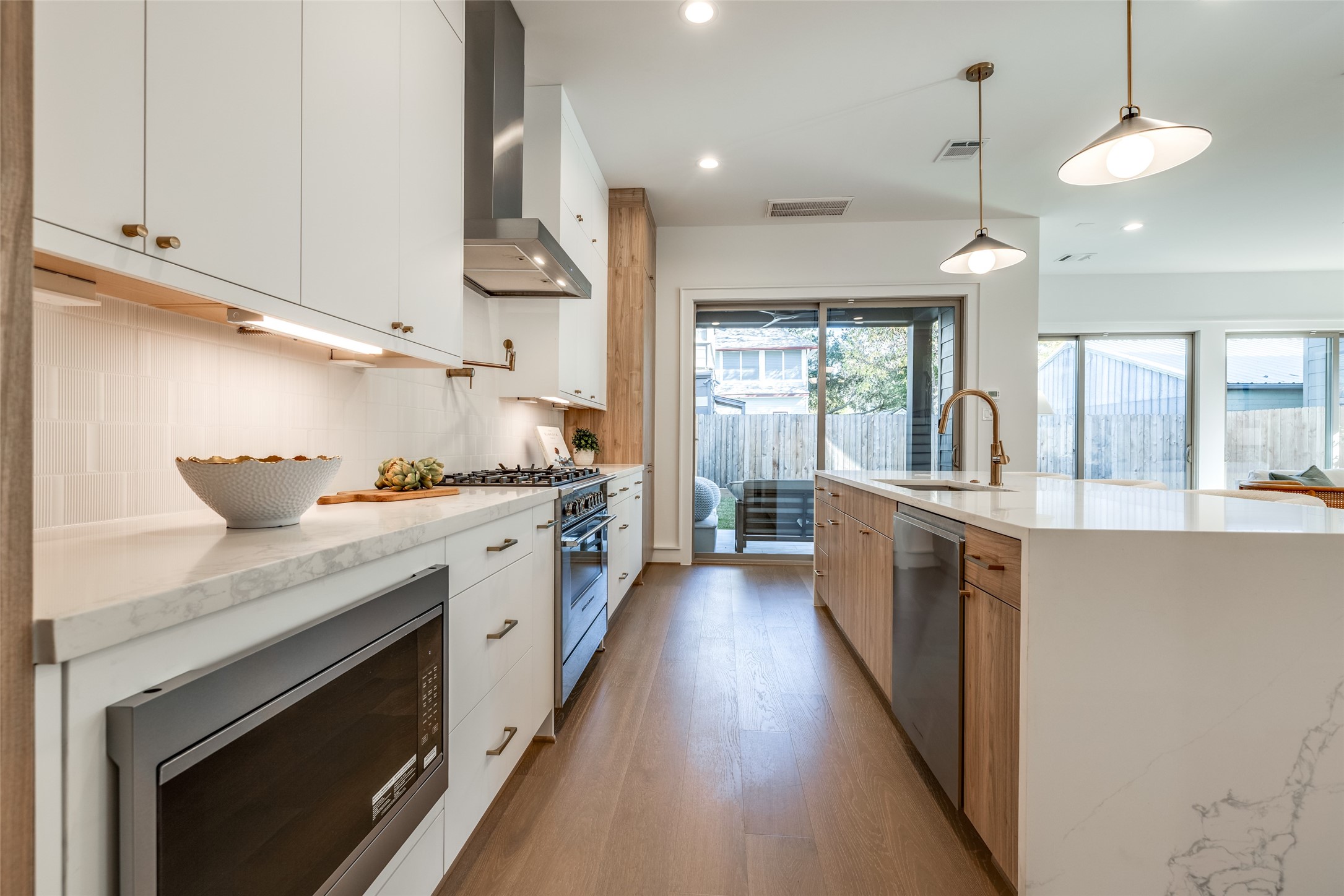 1601 Vermont Street Houston, TX 77006 - Photo 24 of 46 a kitchen with stainless steel appliances granite countertop a lot of counter space and wooden floors