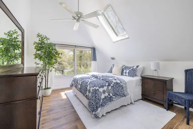 a living room with a bed furniture and a large window