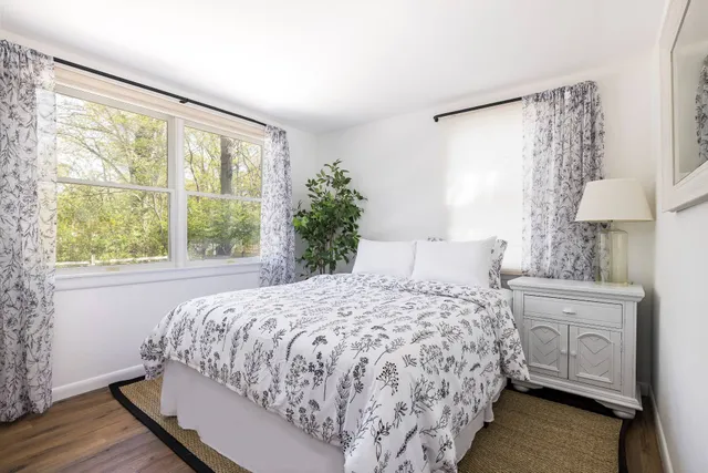 a bedroom with a large bed and a window