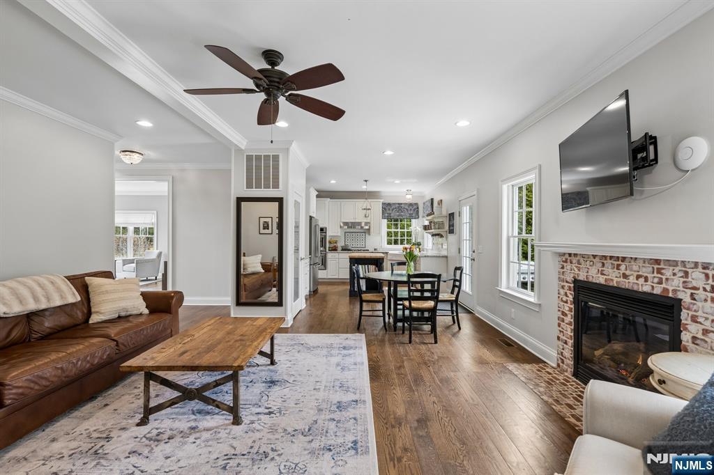 44 Millbrook Road New Vernon, NJ 07976 - Photo 11 of 45 a living room with furniture a fireplace and a ceiling fan