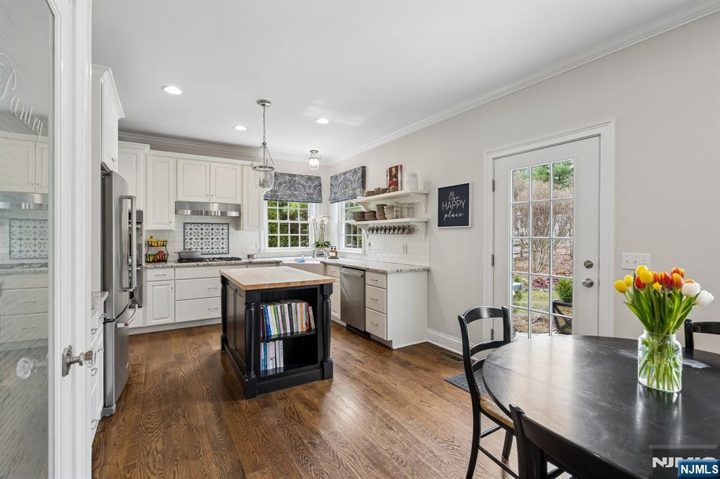 44 Millbrook Road New Vernon, NJ 07976 - Photo 15 of 45 a kitchen with stainless steel appliances granite countertop a stove refrigerator dining table and chairs