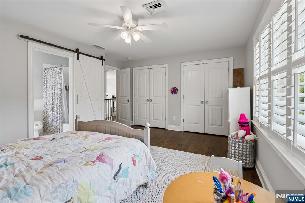44 Millbrook Road New Vernon, NJ 07976 - Photo 28 of 45 a bedroom with a bed chandelier and a window