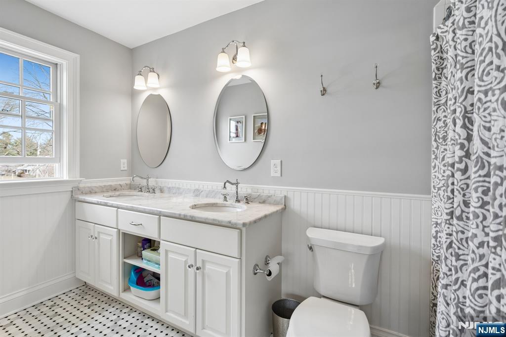 44 Millbrook Road New Vernon, NJ 07976 - Photo 29 of 45 a bathroom with a toilet a sink and a mirror