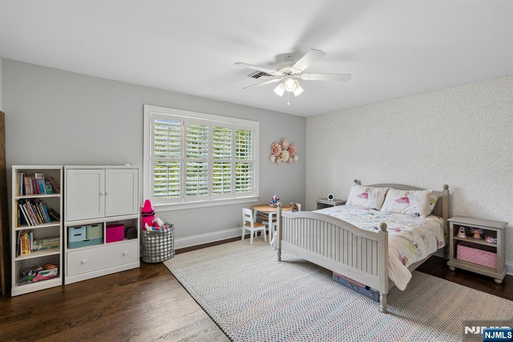 44 Millbrook Road New Vernon, NJ 07976 - Photo 30 of 45 a bedroom with a bed and a chandelier