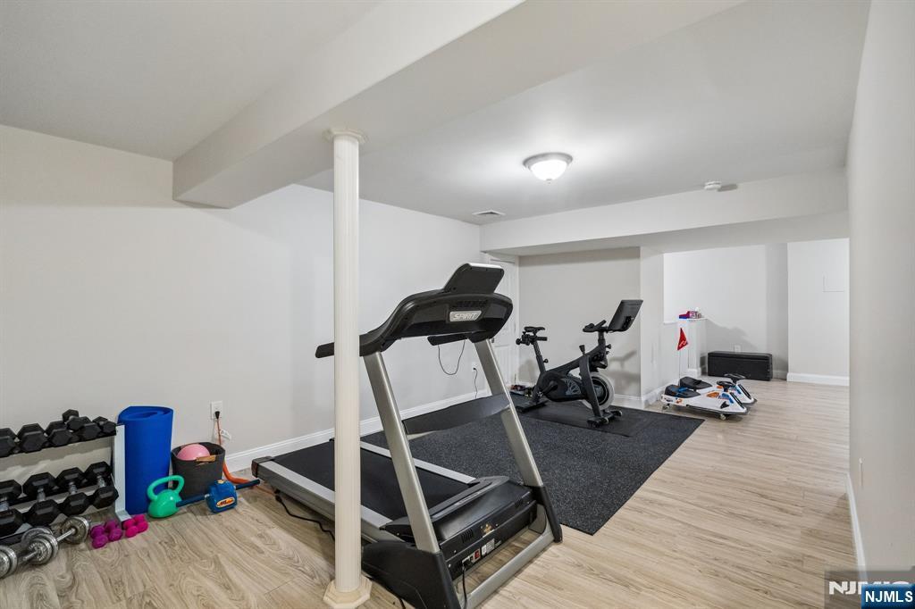44 Millbrook Road New Vernon, NJ 07976 - Photo 37 of 45 a room with gym equipment and wooden floor