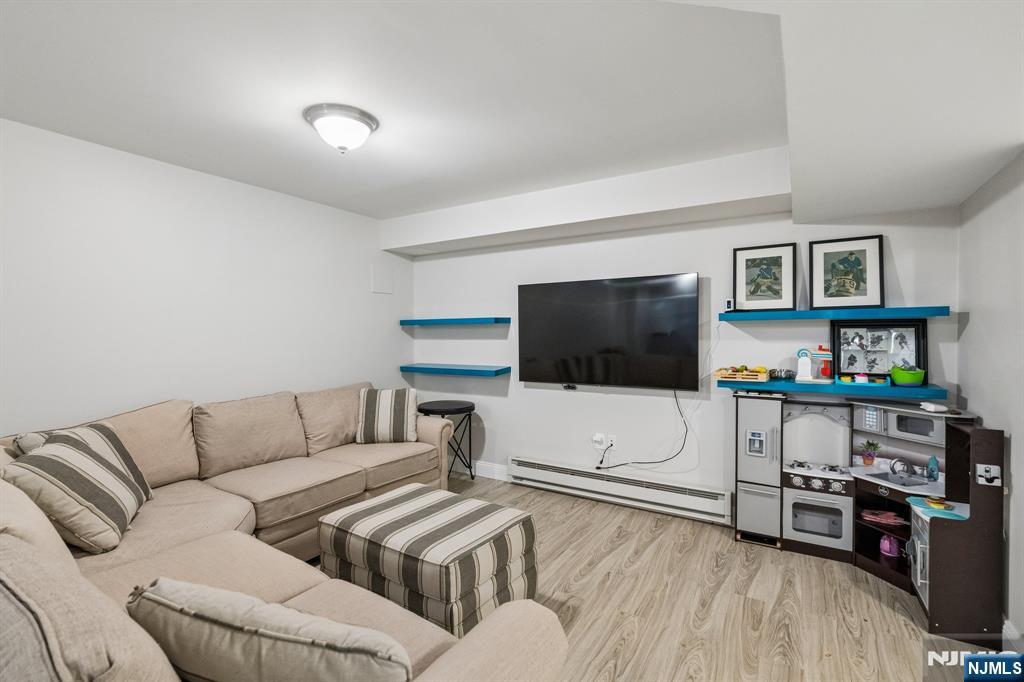44 Millbrook Road New Vernon, NJ 07976 - Photo 38 of 45 a living room with furniture and a flat screen tv