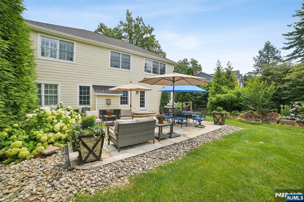 44 Millbrook Road New Vernon, NJ 07976 - Photo 40 of 45 a view of a house with backyard sitting area and garden