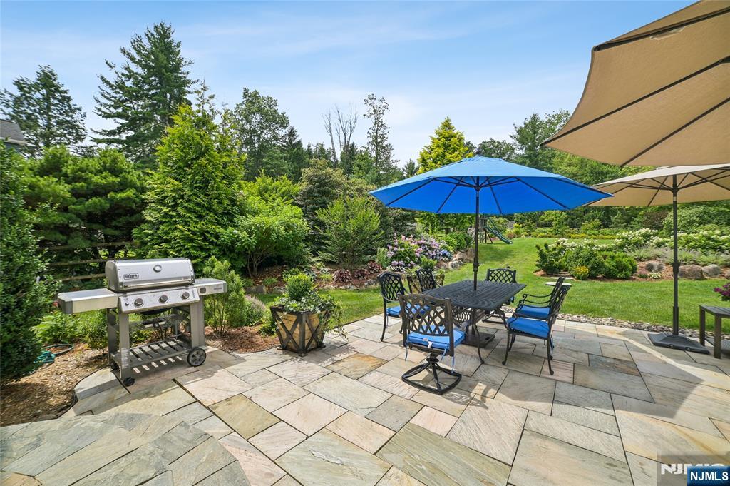 44 Millbrook Road New Vernon, NJ 07976 - Photo 41 of 45 a view of a patio with table and chairs under an umbrella