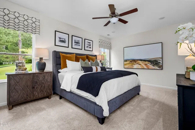 a bedroom with a bed and dresser with mirror