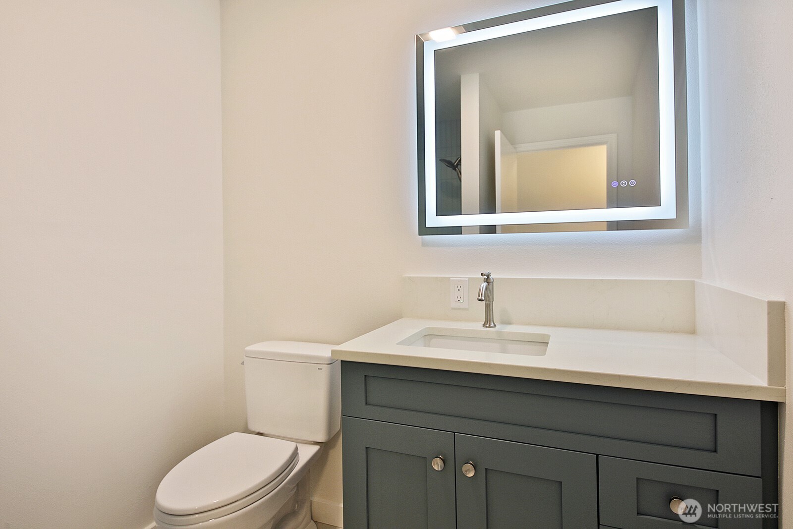 3760 Periwinkle Road Clinton, WA 98236 - Photo 25 of 34 a bathroom with a toilet sink and mirror