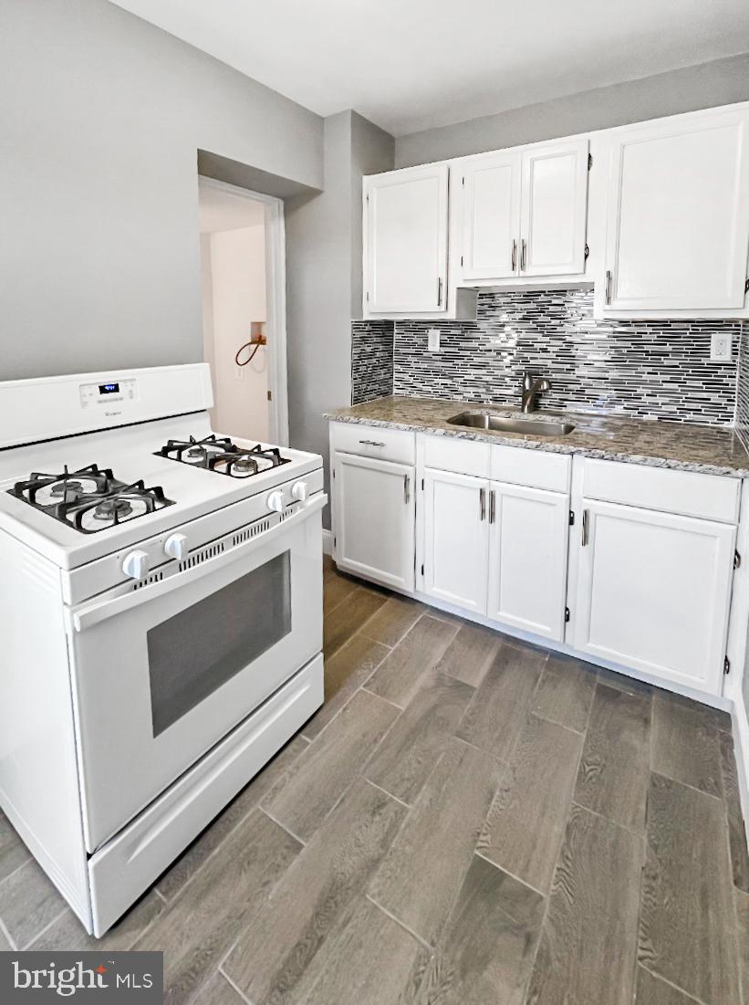 1434 Light Street Baltimore, MD 21230 - Photo 11 of 20 a kitchen with stainless steel appliances white cabinets and a stove a sink