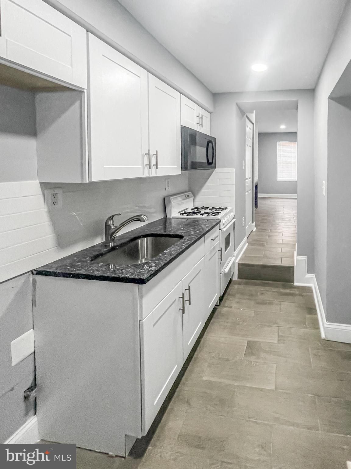 1434 Light Street Baltimore, MD 21230 - Photo 20 of 20 a large kitchen with stainless steel appliances granite countertop a sink and cabinets