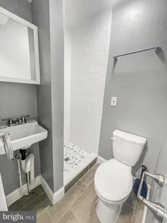 a bathroom with a sink toilet and a mirror