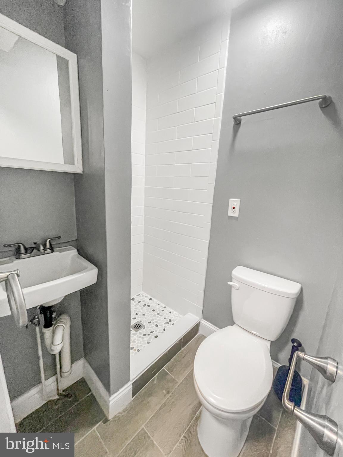 1434 Light Street Baltimore, MD 21230 - Photo 6 of 20 a bathroom with a sink toilet and a mirror