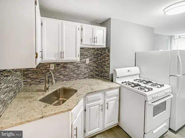 a kitchen that has a sink and a stove