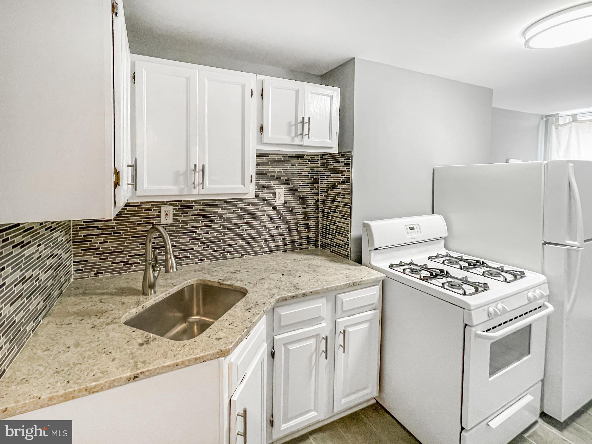 1434 Light Street Baltimore, MD 21230 - Photo 8 of 20 a kitchen that has a sink and a stove