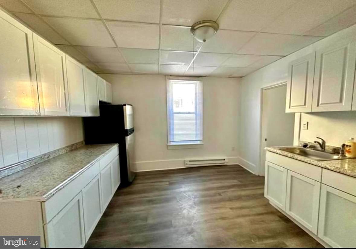 132 Arch Street Cumberland, MD 21502 - Photo 2 of 10 a kitchen with stainless steel appliances granite countertop a sink stove and refrigerator