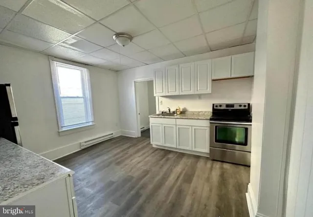 a kitchen with a stove and white cabinets