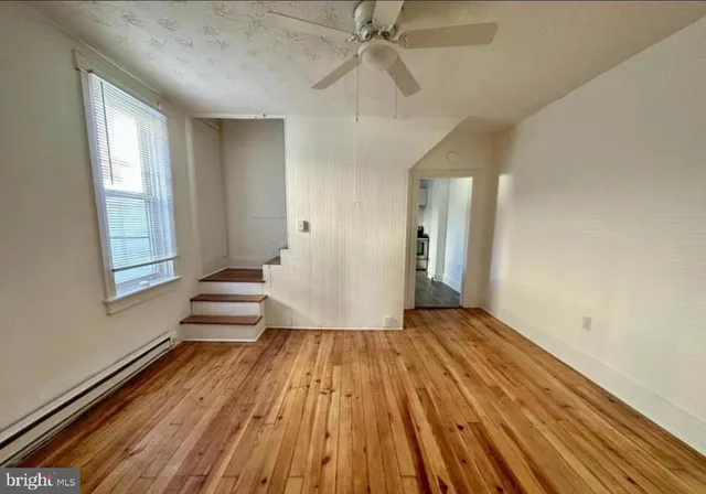 wooden floor in an empty room with a window