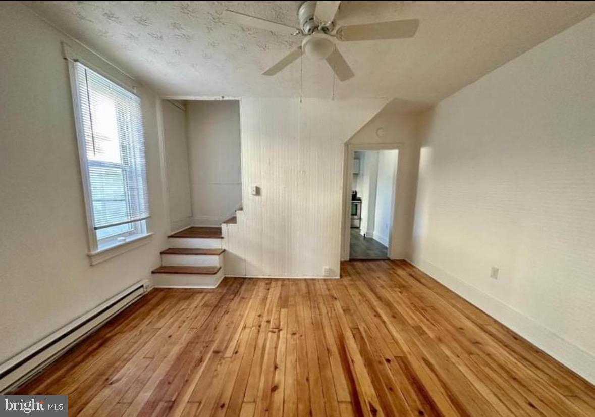 132 Arch Street Cumberland, MD 21502 - Photo 4 of 10 wooden floor in an empty room with a window