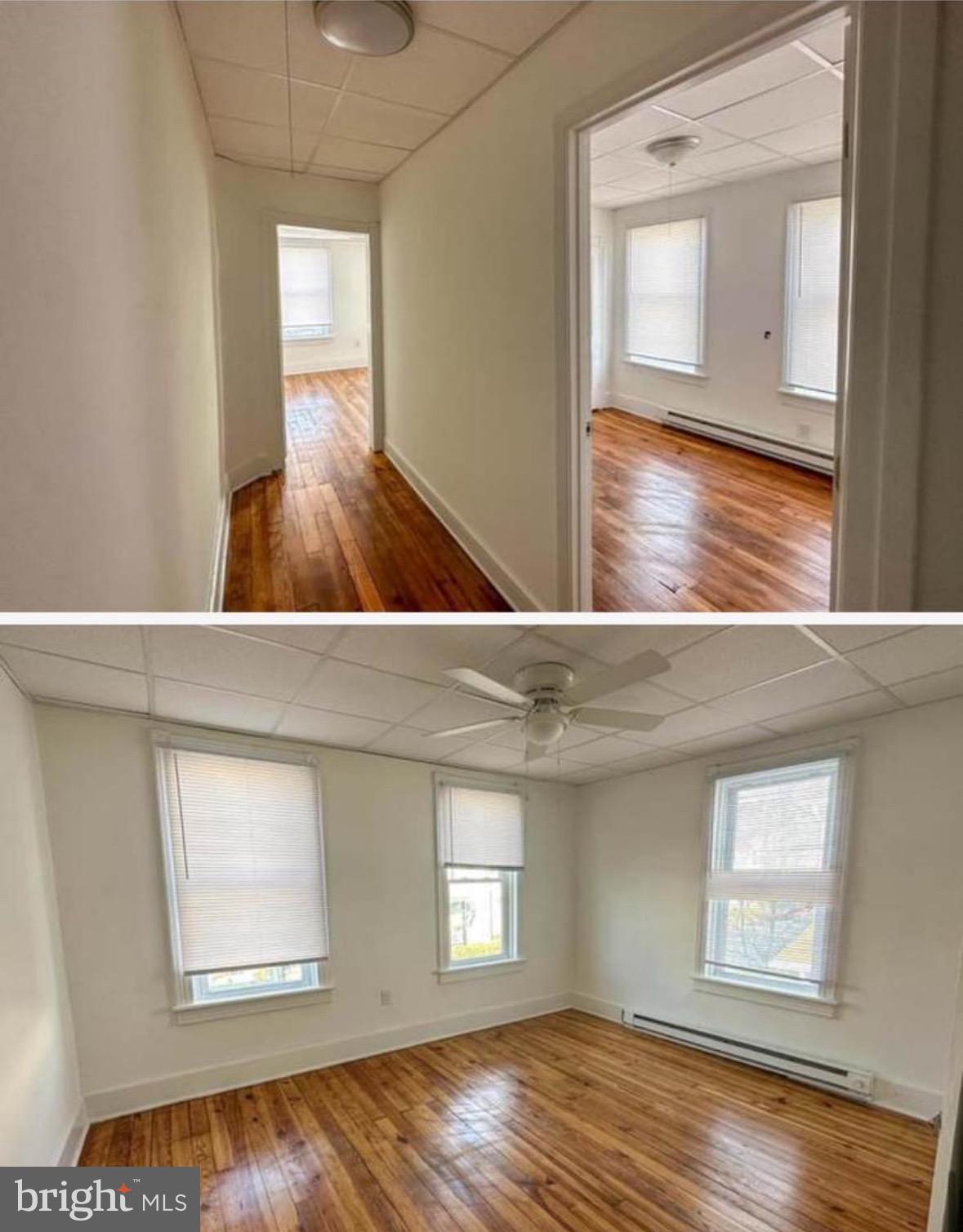 132 Arch Street Cumberland, MD 21502 - Photo 7 of 10 a view of an empty room with wooden floor and a window