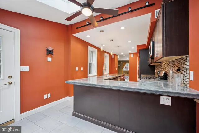 a kitchen with stainless steel appliances granite countertop a sink a granite counter top and a granite counter tops