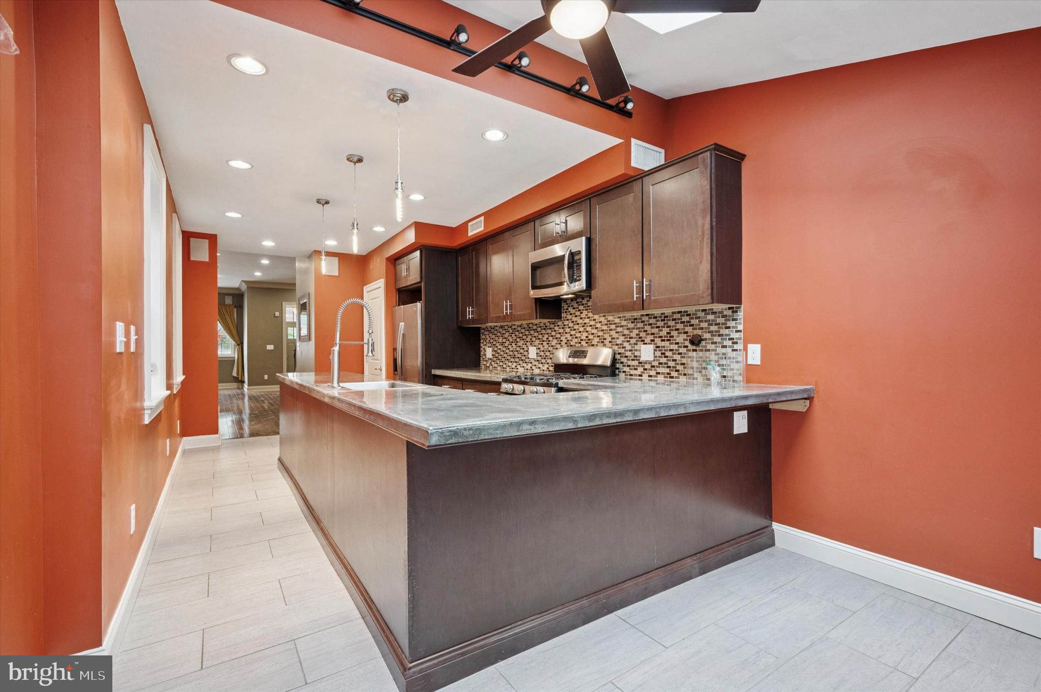 2351 East York Street Philadelphia, PA 19125 - Photo 12 of 44 a view of kitchen island with stainless steel appliances granite countertop sink stove and refrigerator