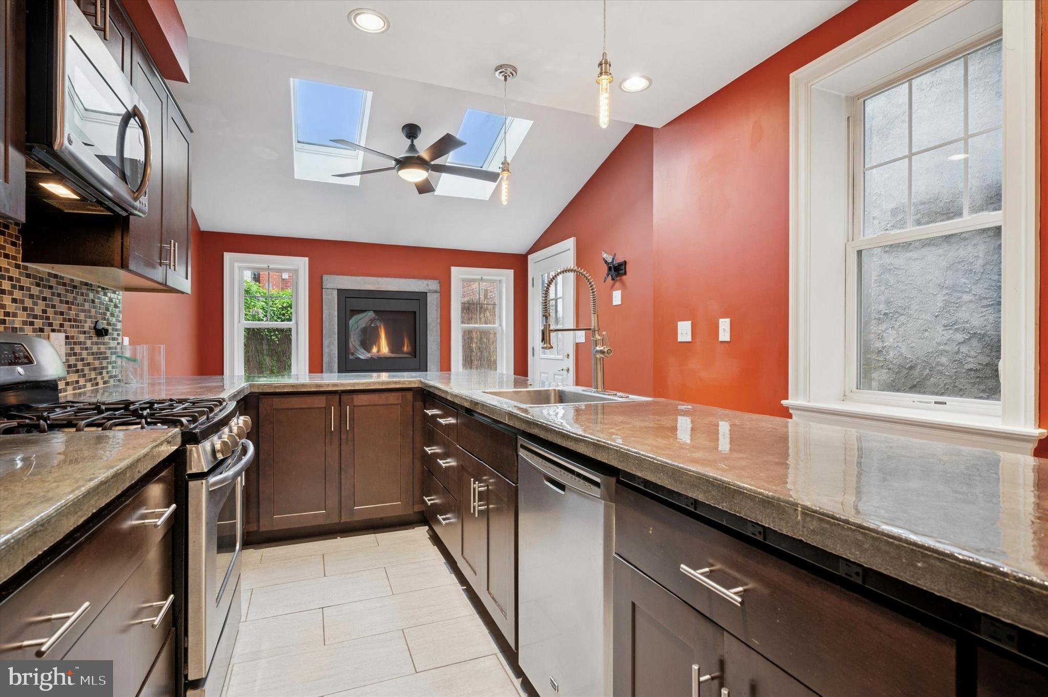 2351 East York Street Philadelphia, PA 19125 - Photo 15 of 44 a kitchen with stainless steel appliances granite countertop a stove a sink and a microwave