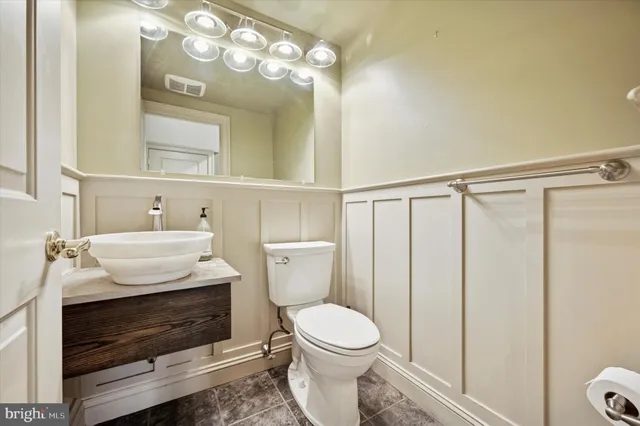 a bathroom with a sink a toilet and mirror