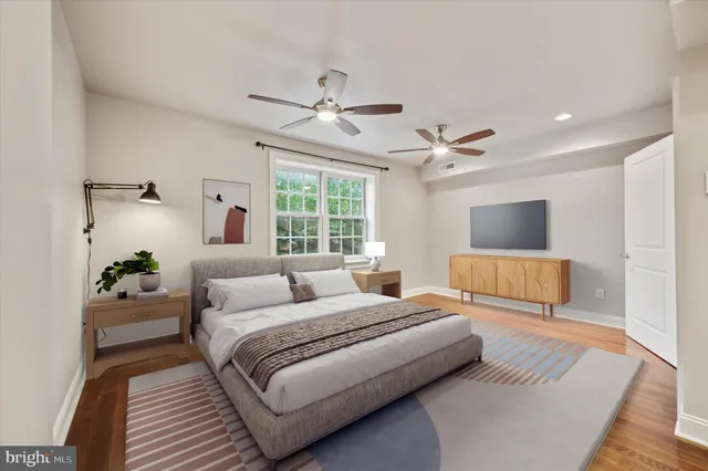 a bedroom with a large bed and a window