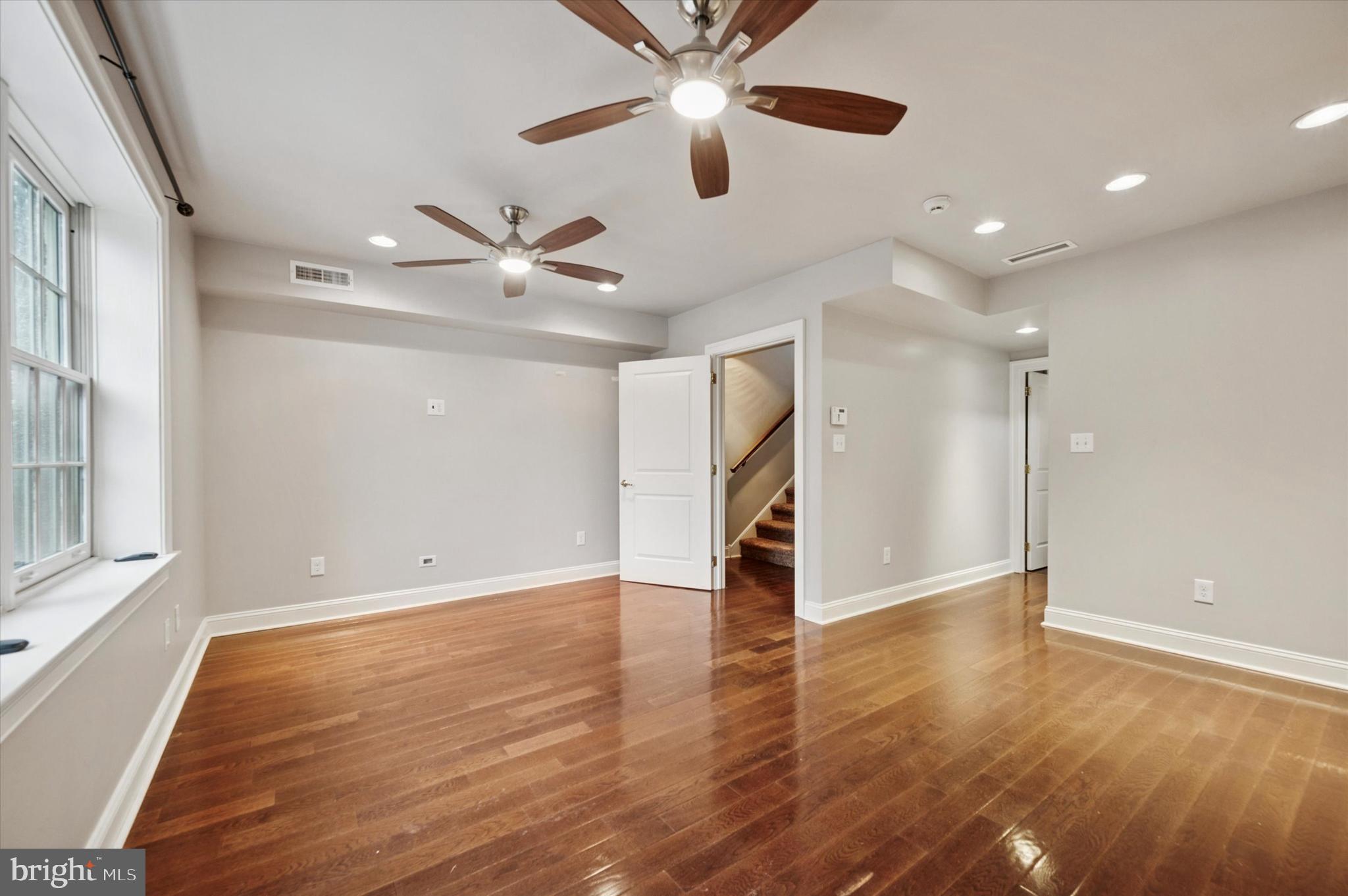 2351 East York Street Philadelphia, PA 19125 - Photo 23 of 44 a view of an empty room with window and wooden floor