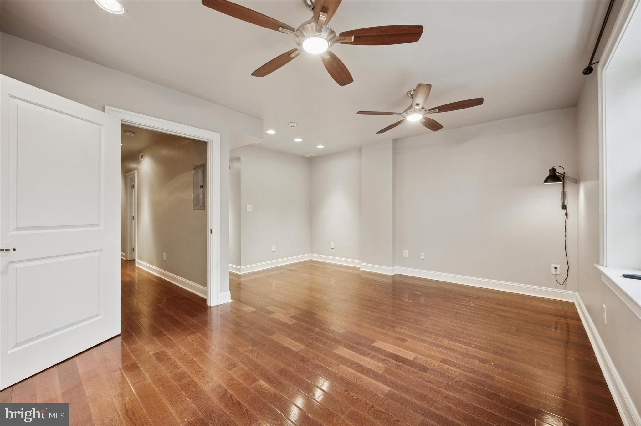 2351 East York Street Philadelphia, PA 19125 - Photo 24 of 44 an empty room with wooden floor fan and windows
