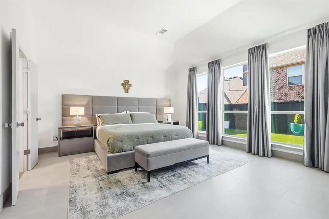 a spacious bedroom with a bed and a window