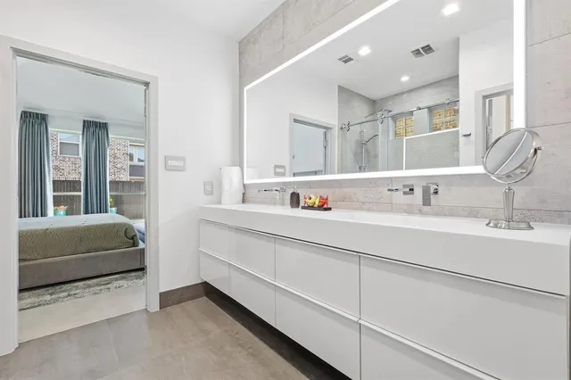 a bathroom with a double vanity sink mirror and double