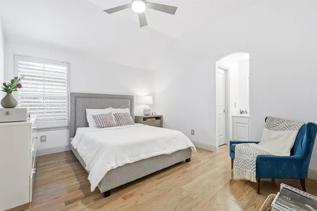 a bedroom with a bed and a chair