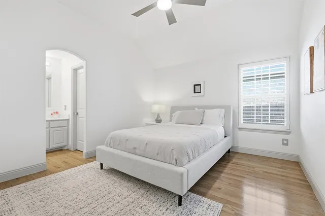 a bedroom with a bed and a ceiling fan