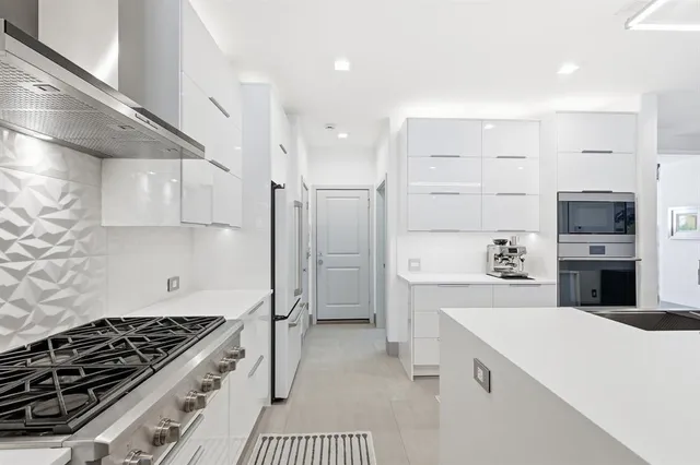 a kitchen with a stove a refrigerator and a cabinets