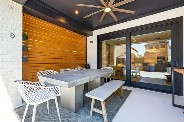 a balcony with a table and chairs