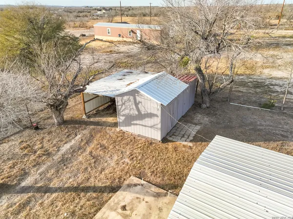 a view of a wooden house with a yard