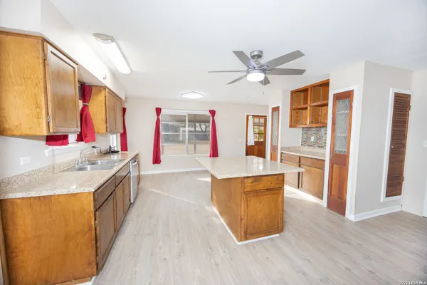 a kitchen with stainless steel appliances granite countertop a sink and a refrigerator