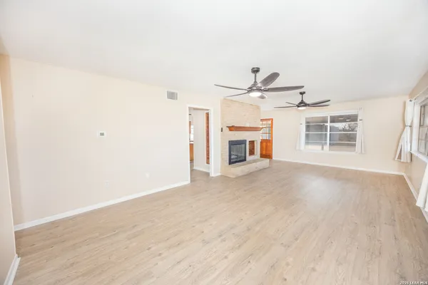 a view of empty room with a fireplace
