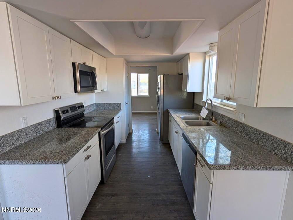 848 C Street Fernley, NV 89408 - Photo 5 of 15 a kitchen with granite countertop a sink and a stove top oven