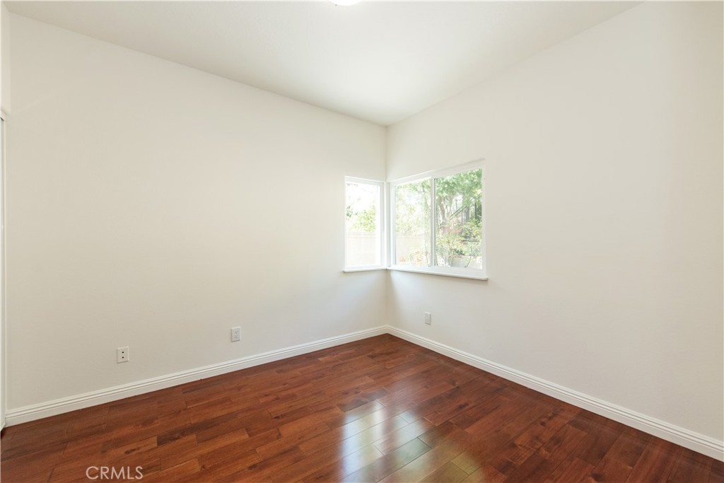 19933 Hidden Springs Road Walnut, CA 91789 - Photo 11 of 26 an empty room with wooden floor and windows