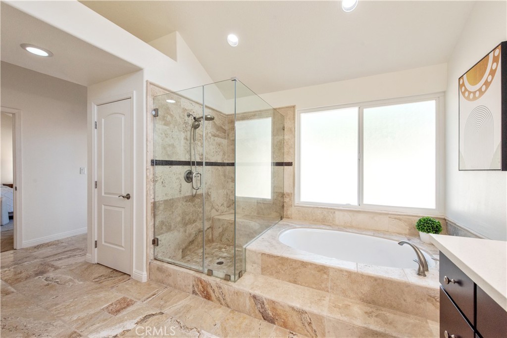 19933 Hidden Springs Road Walnut, CA 91789 - Photo 16 of 26 a spacious bathroom with a granite countertop tub shower and sink