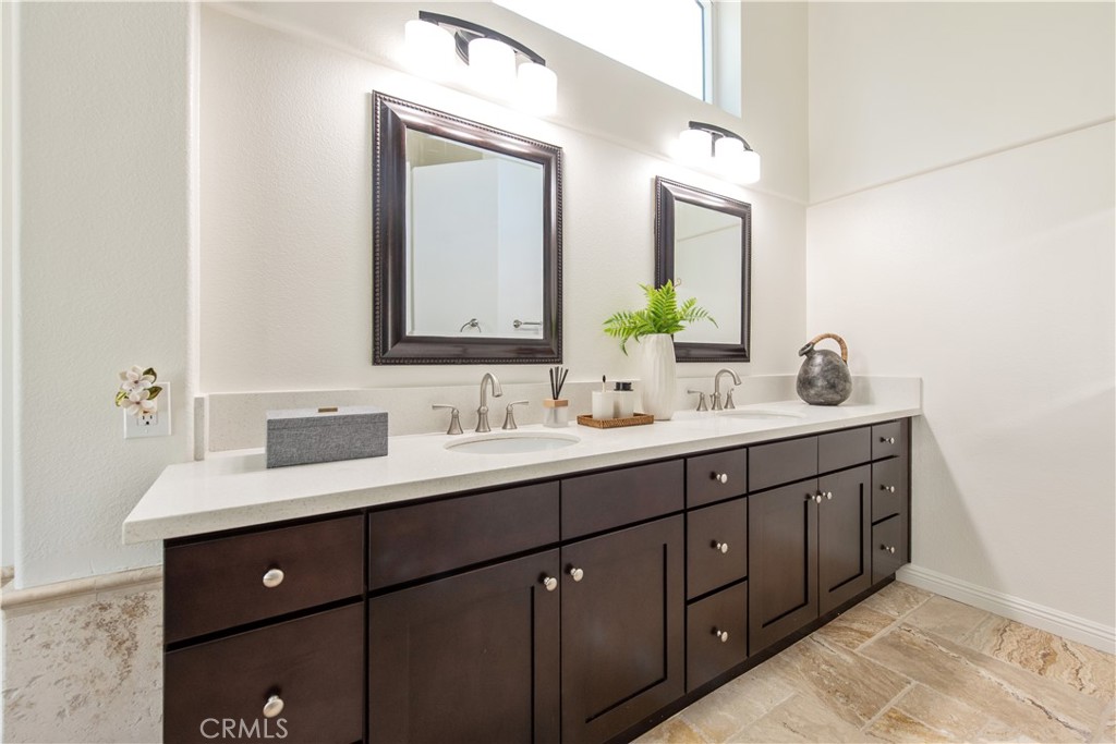 19933 Hidden Springs Road Walnut, CA 91789 - Photo 17 of 26 a bathroom with a double vanity sink and mirror